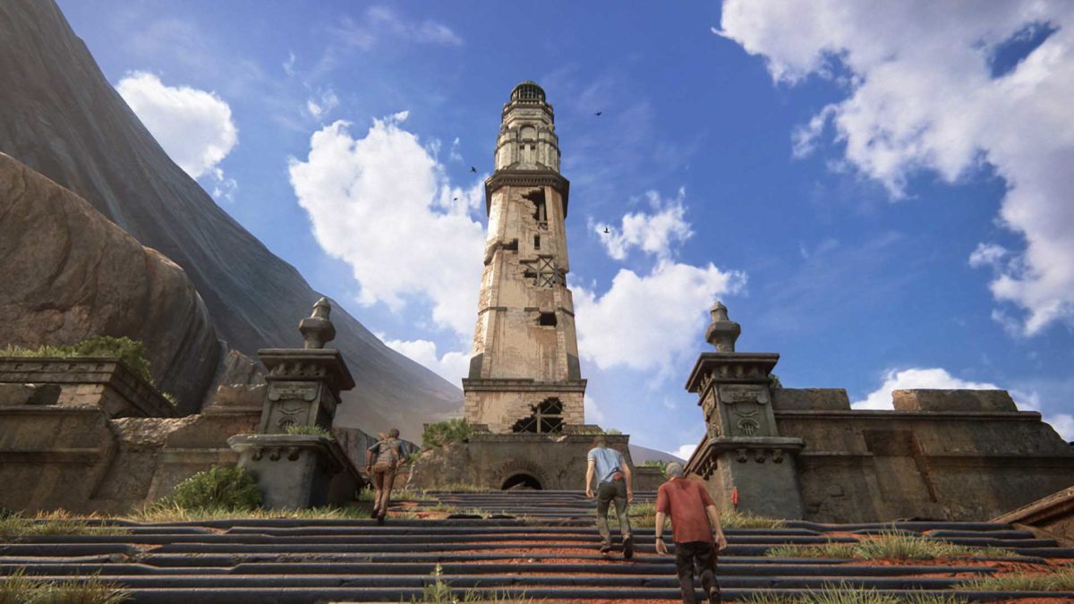 Nathan Drake, Sam Drake e Victor Sullivan salgono le scale verso una torre in rovina