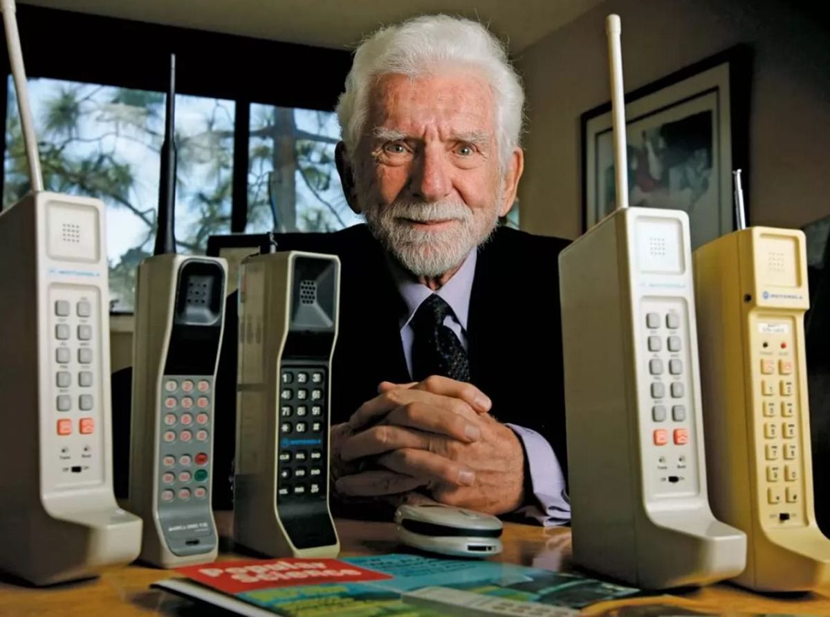 Martin Cooper e alcuni dei primi cellulari inventati.