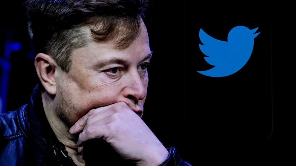 Musk pensieroso vicino al logo Twitter