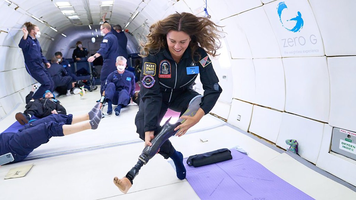 Una donna sfila la protesi dalla gamba mentre lievita in aria durante un lancio a gravità zero 