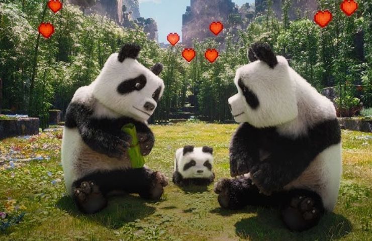 scena del film di Minecraft con due panda adulti e un panda cucciolo in una prateria verde