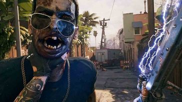 uomo con arma elettrica che tiene per il collo zombie con occhiali da sole