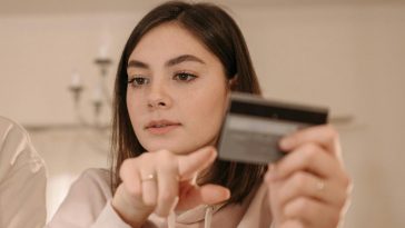 Ragazza che indica una carta di credito