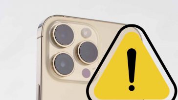 iphone dorato con segnale di pericolo