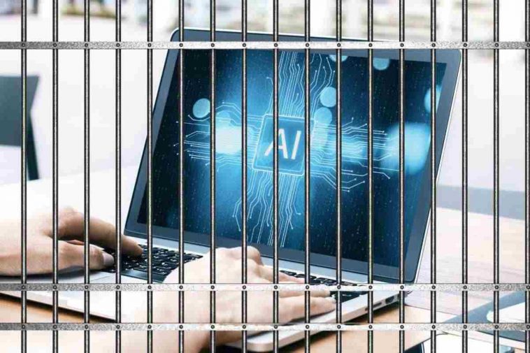 uomo al pc dietro le sbarre