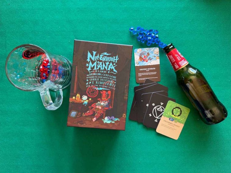 Scatola del gioco da tavolo Not Enough Mana accompagnata dalle sue carte di gioco, segnalini, bottiglie e boccali vuoti