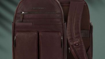 zaino Piquadro fronte retro su sfondo verde scuro