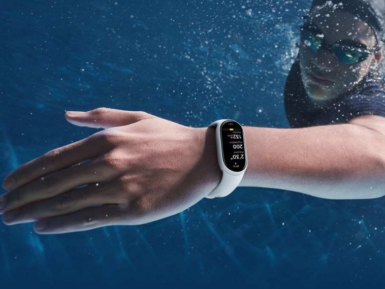 persona che nuota sott'acqua indossando uno xiaomi smart band