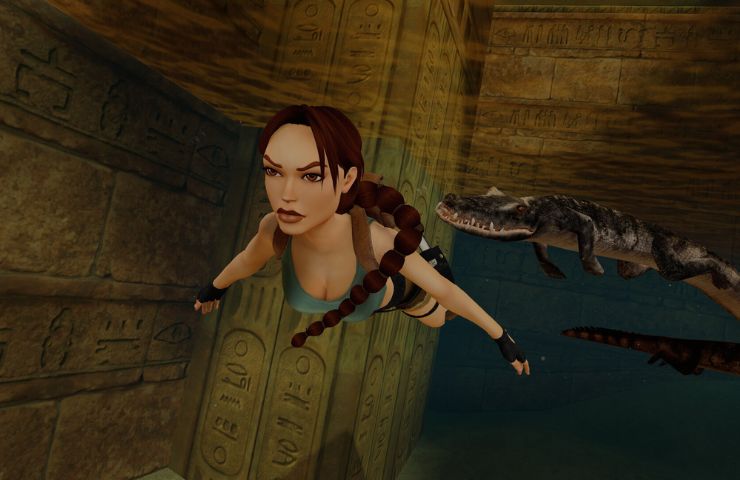 screenshot di tomb raider remastered con lara croft che nuota con un coccodrillo