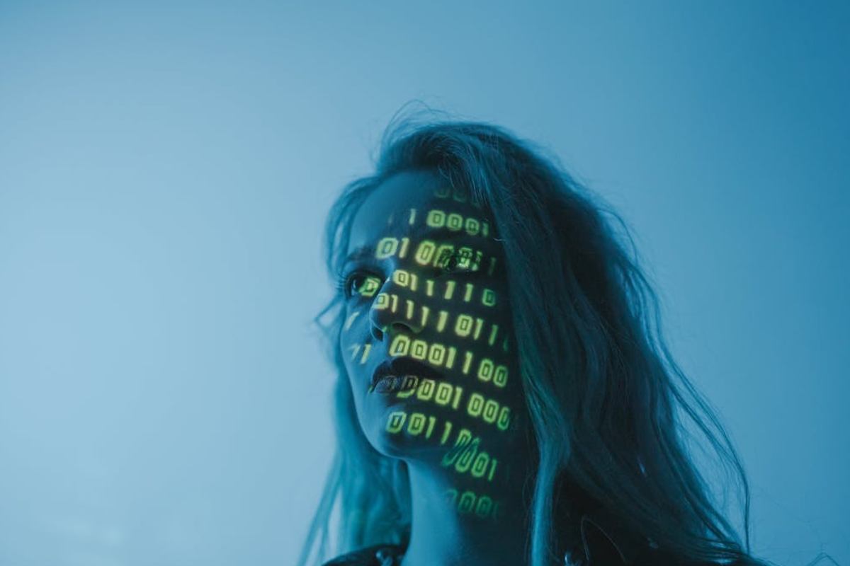 Un volto di donna con riflessi di codici informatici