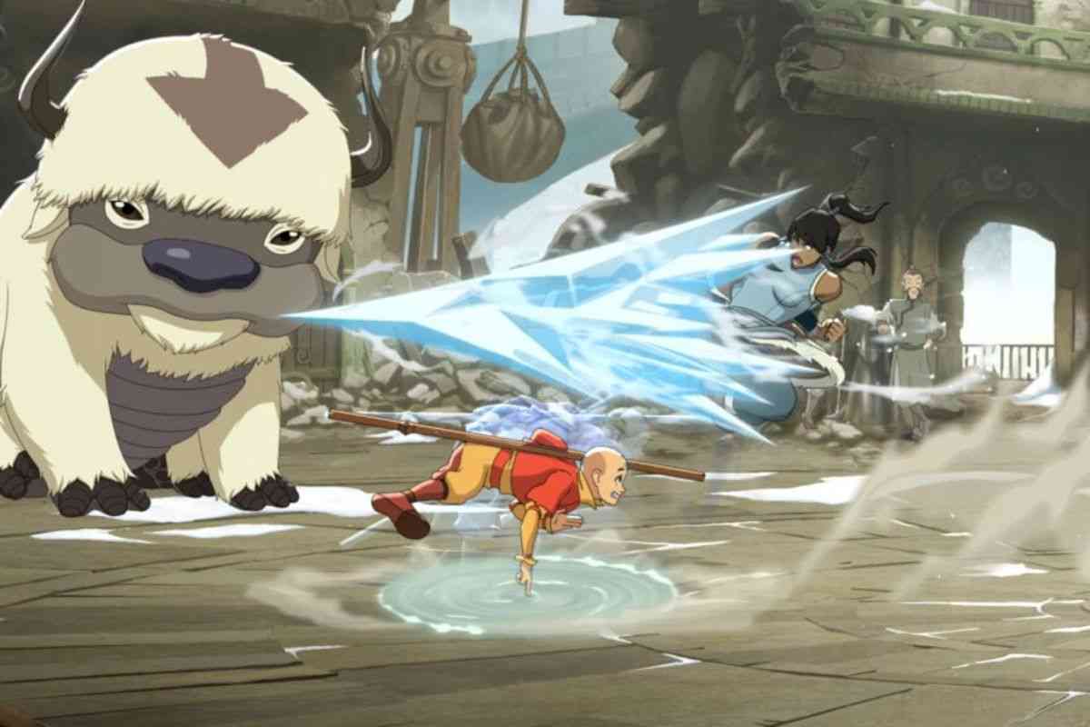 personaggio con veste gialla e arancione che combatte con personaggio femminile, lastra di ghiaccio, animale grosso sullo sfondo