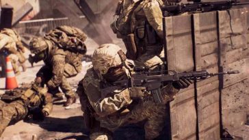 soldati con fucili schierati dietro muro di legno