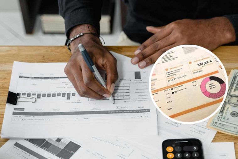 Un uomo che fa i conti analizzando le bollette e, in evidenza, una fattura energetica