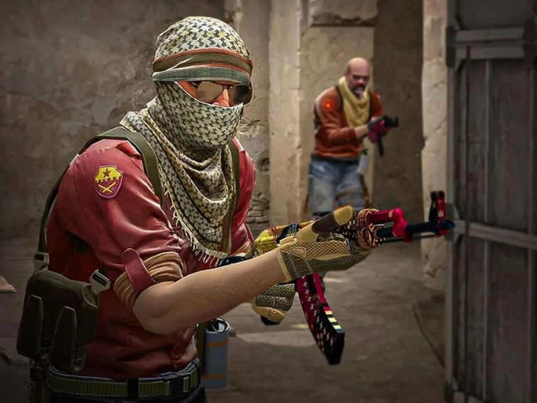 uomo con fazzoletto a coprire la testa co fucile in mano, alle spalle uomo a viso scoperto con fucile in mano