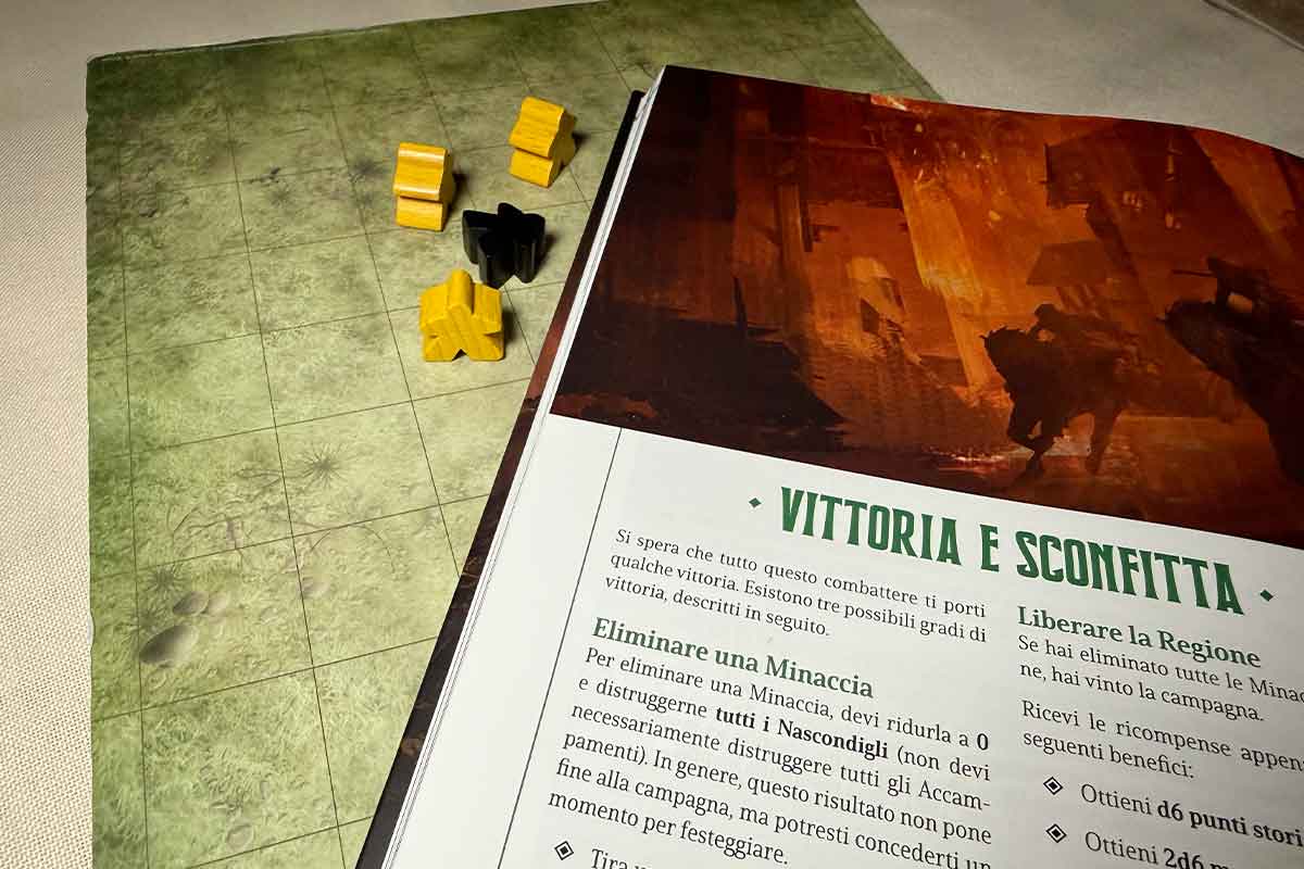 Il Manuale di Cinque Leghe dal Confien aperto alla pagina di vittoria e sconfitte con i meeple che indicano una battaglia appena eseguita