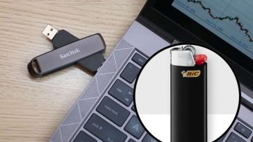 Un portatile con una pennetta collegata e, in evidenza, un accendino bic nero