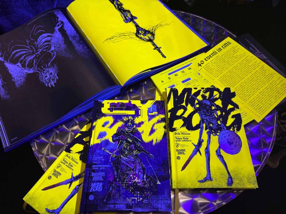 Artbook Art By Nohr e manuali di Mörk Borg e CY_Borg, illuminati da una luce al neon alla mostra dedicata a Johan Nohr al Lucca Comics & Games 2025