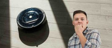 robot aspirapolvere e uomo preoccupato