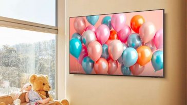 Samsung Smart TV appeso alla parete con palloncini colorati sullo schermo