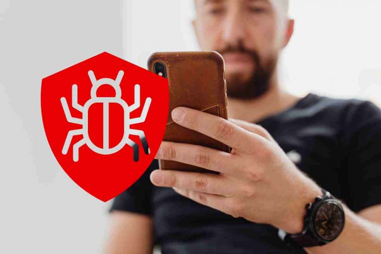 uomo telefono e simbolo malware