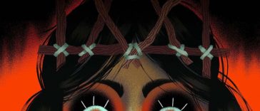 VIso ragazza con trucco nero attorno a occhi e corna fatte con rami