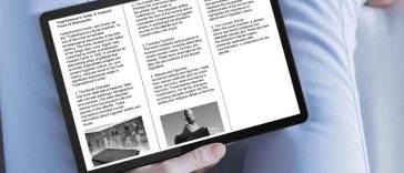 persona legge articolo di giornale su tablet messo su gambe